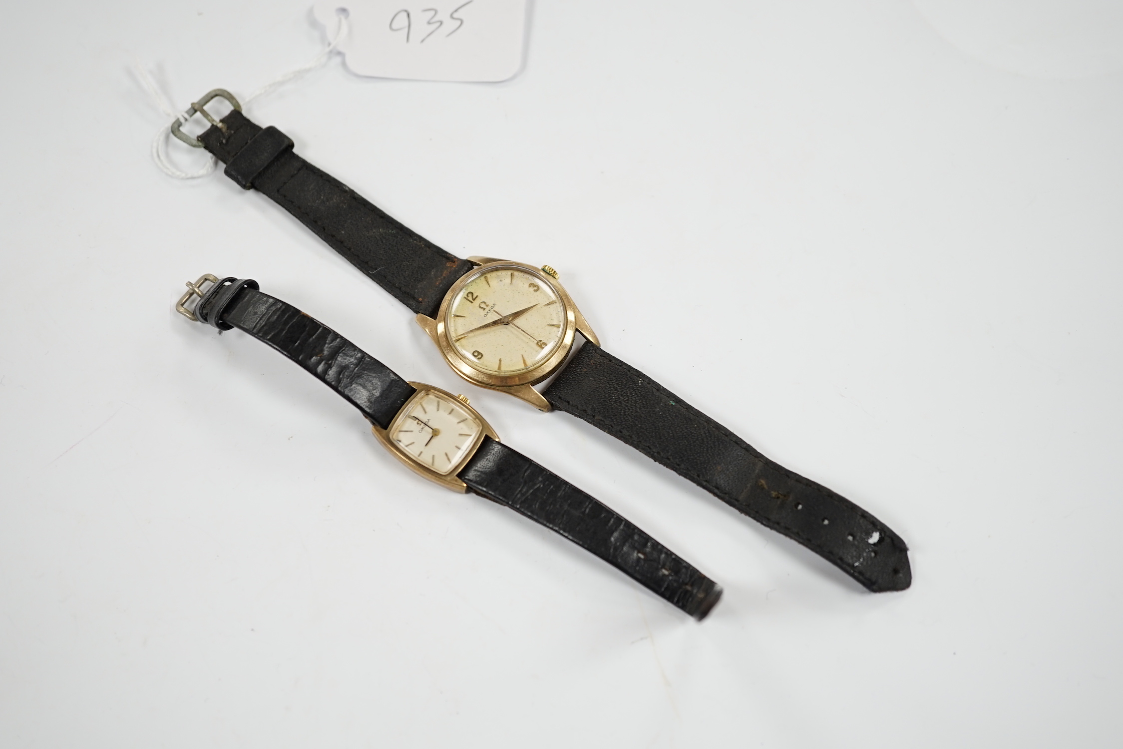 A gentleman's 9ct gold Omega manual wind wrist watch, on associated strap and a lady's 9ct gold Omega manual wind wrist watch.
